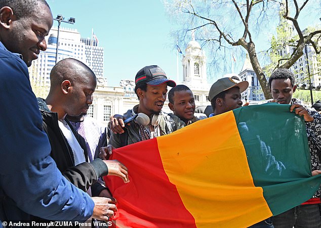 Hundreds of migrants gathered outside NYC City Hall on Tuesday ahead of a City Council oversight hearing focused on the experiences of Black migrants