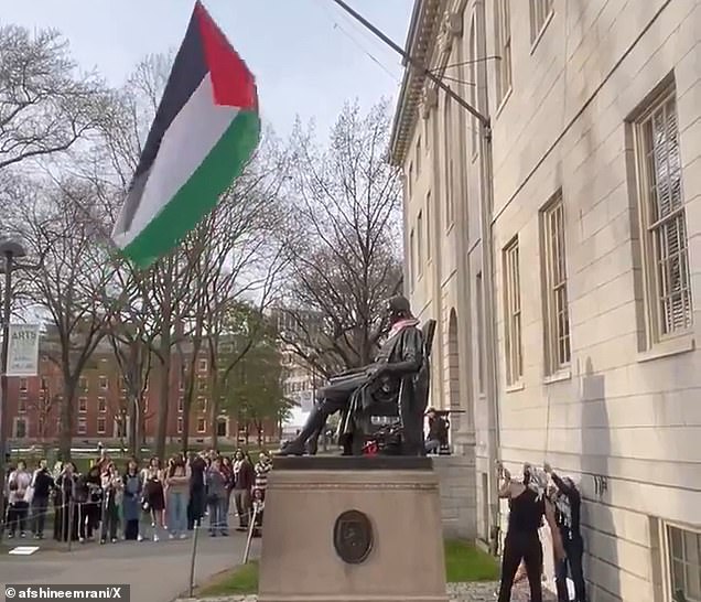 On Saturday evening, a group of pro-Palestinian protesters dressed in keffiyehs raised a large Palestinian flag over the founder's memorial.