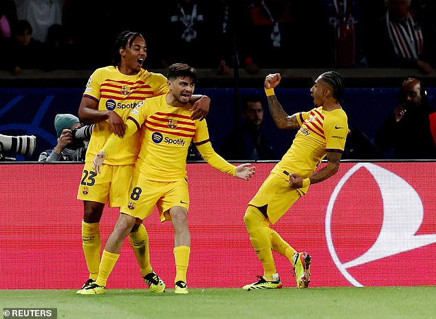 Barcelona's Raphinha (R) celebrates his second goal with Jules Kounde and Pedri