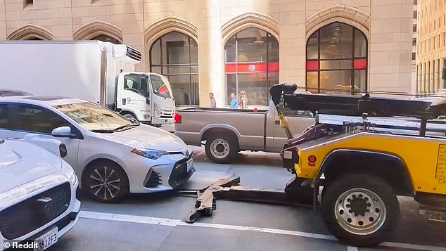 In one video, a tow truck driver in San Francisco was seen attempting to tow a car while the driver was still inside