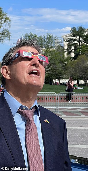 Sen. Joe Manchin, D-W.V., looks at the 2024 solar eclipse