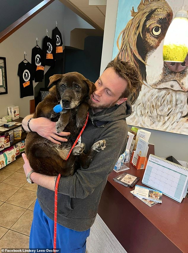 Fiona is pictured here in the arms of a caregiver at Albert's Dog Lounge in Wisconsin