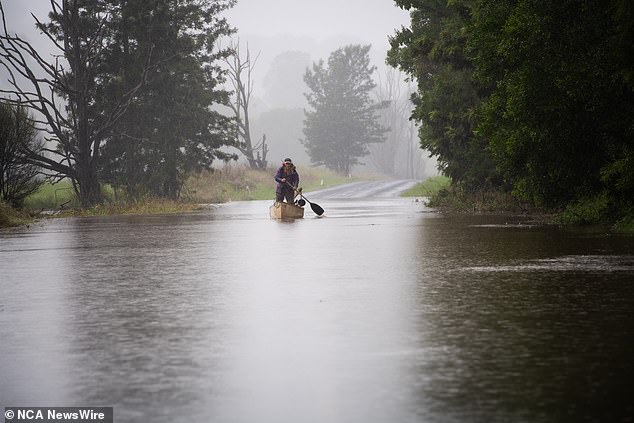 All NSW residents have been told not to leave their homes unless their travel is 'essential' as extreme weather wreaks havoc on the east coast.  Lismore is pictured on Friday