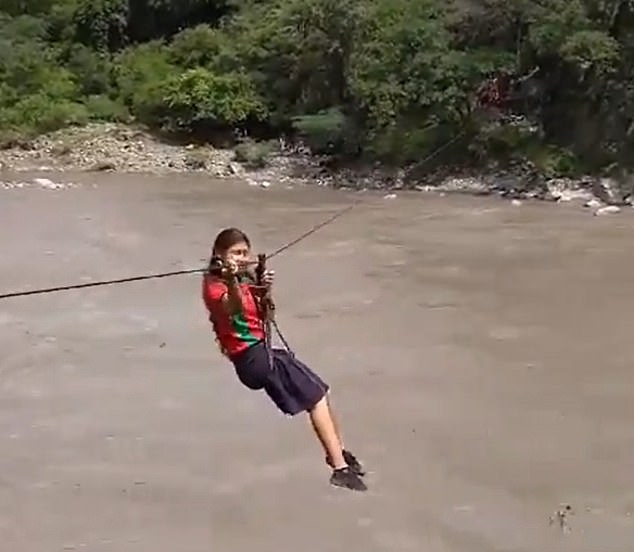 A schoolgirl zips 100 meters across the Chicamocha River to reach her school, almost five years after a storm destroyed a pedestrian bridge connecting the rural neighborhoods of Felisco and Palmas de Felisco of Molagavita with Rio Chico, a sector in the municipality of Mogotes where the school is located.  is located