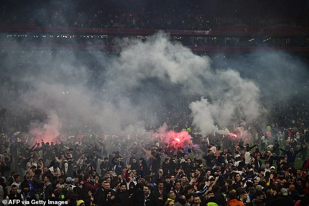 Thousands of Lyon fans took to the pitch and lit flares after their team reached the French Cup final on Tuesday