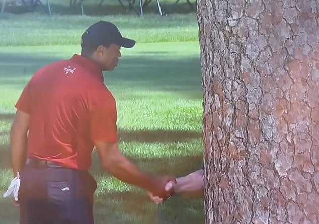 Tiger Woods paused his tough final round to share a moment with a mysterious individual