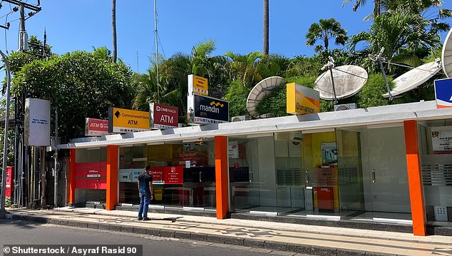 A row of ATMs is pictured along the road in Kuta