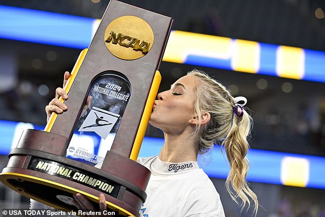 Dunne celebrates with the national championship trophy after LSU's win on Saturday