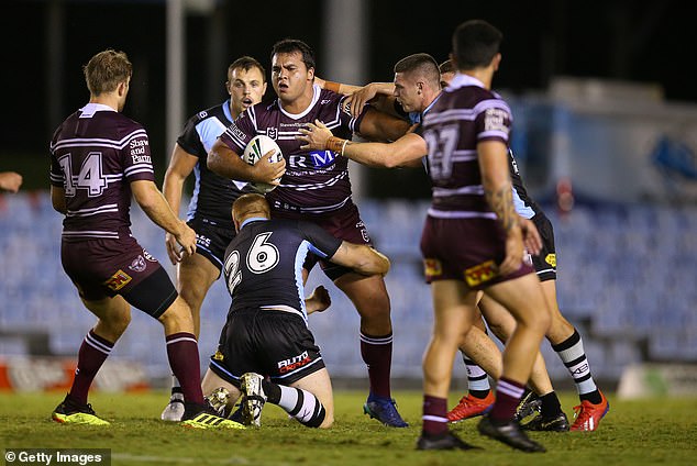 Perrett (pictured with the ball for Manly) said he was 'literally on my deathbed' when he woke up in hospital after the terrifying medical episode