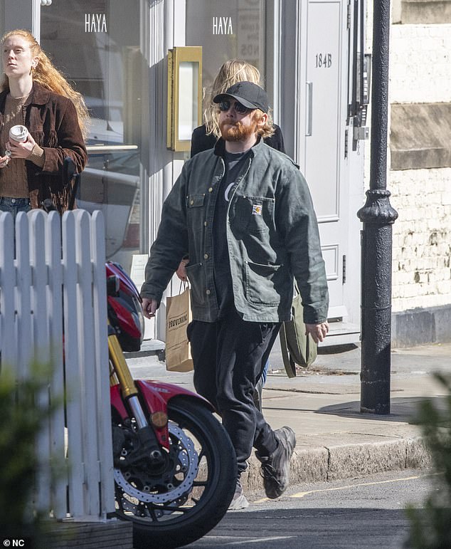 He also wore a black cap and sunglasses during the outing