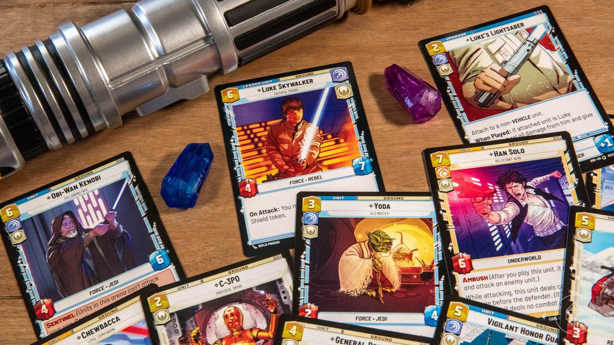An assortment of cards from the Luke Skywalker starter deck featuring various Kyber crystals and a lightsaber.