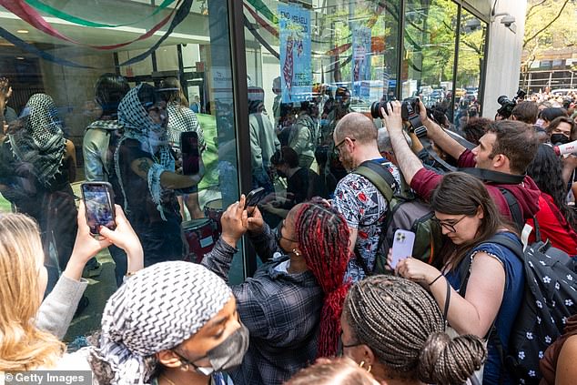 Pro-Palestinian protesters gather outside Fordham's Lincoln Center campus after a group created an encampment in the building