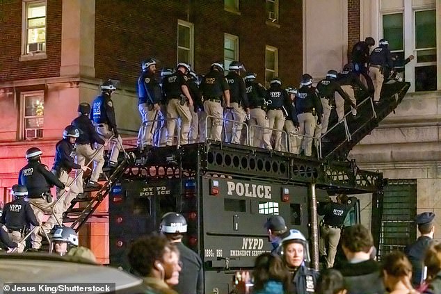 Police in anti-riot gear enter the Columbia University building that pro-Palestinian student demonstrators had taken over.  They arrested about 300