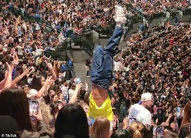 Another disruptive fan tried to do a handstand in the elevated seating area, but lost his balance and fell on another audience member