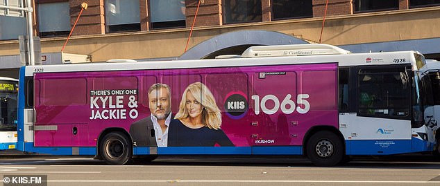 The new Nova FM presenters hosted a cash giveaway in a Melbourne park on Thursday morning when a KIIS FM Kyle and Jackie O Show branded bus appeared.  Pictured: An advertisement for the Kyle and Jackie O Show on a bus in Sydney