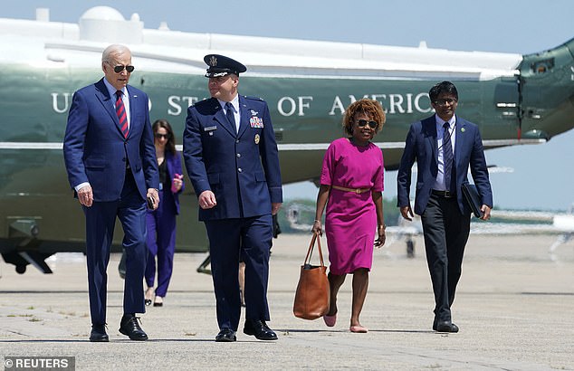 Speaking to reporters aboard Air Force One Thursday, White House Press Secretary Karine Jean-Pierre (center right) would not immediately say whether President Joe Biden (left) intended to call the Japanese 