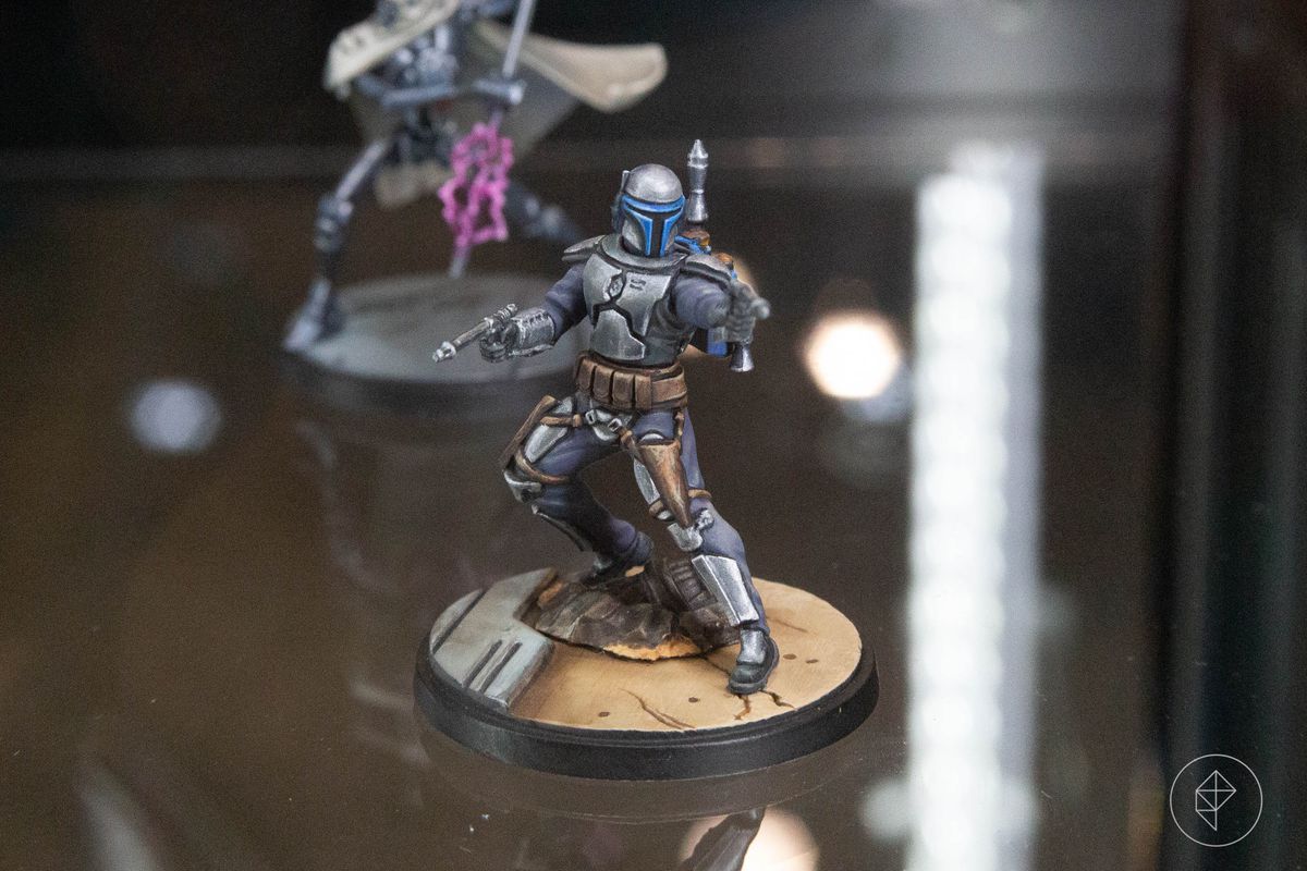 A miniature Jango Fett, raised with blasters like in his final moments in the prequel films.  The brushwork is invisible and the highlights are sharp and clear.