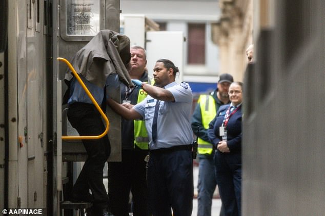 Lindemann covered his head with a jacket as he arrived at the Supreme Court of Victoria in a police van