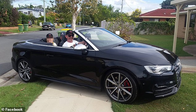 The former police officer poses in his black Audi convertible on November 20