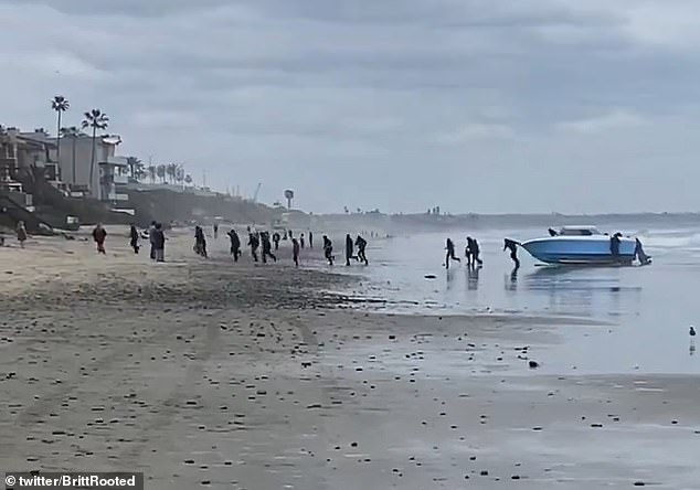 After beaching the ship on the sand, the migrants disembarked and sprinted to the row of oceanfront homes on Saturday