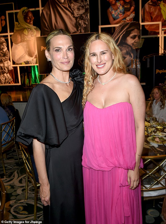 Rumer was also spotted posing at the event with Molly Sims, wearing a black off-the-shoulder dress with her blonde hair pulled back.
