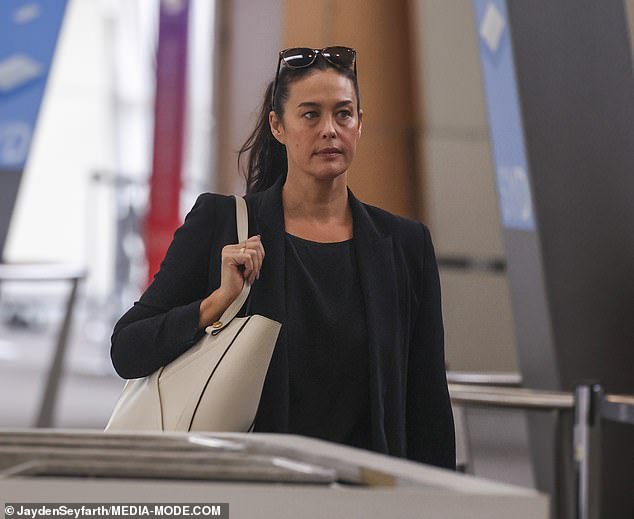 The Perth-born star pulled off a business-chic look in an unbuttoned black blazer teamed with a matching blouse and trousers