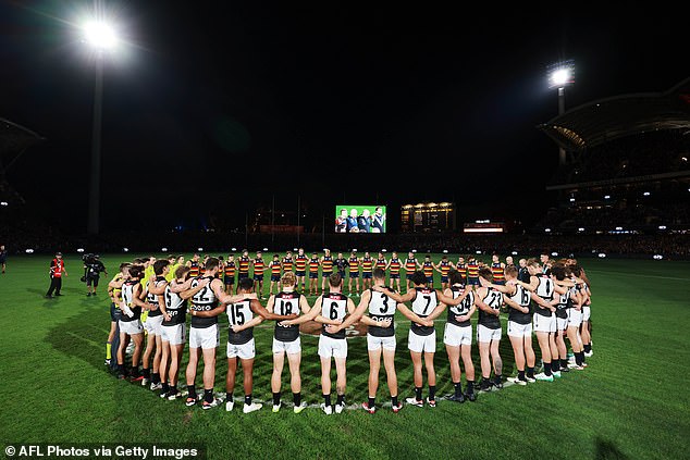 The timing of the Hall of Fame award was terrible for the AFL, which prompts players to make public gestures at every round of 8 match as the league takes a stand on violence against women (photo: Crows and Power players during a minute's silence on Thursday night)