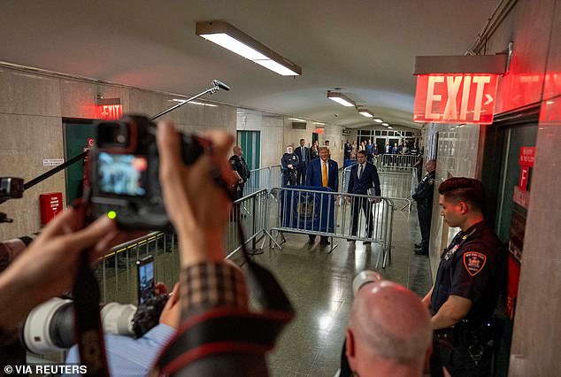 Lucky ticket holders ride the elevator to the 15th floor, where a pen has been set up for Trump to address the assembled media before and after court hearings