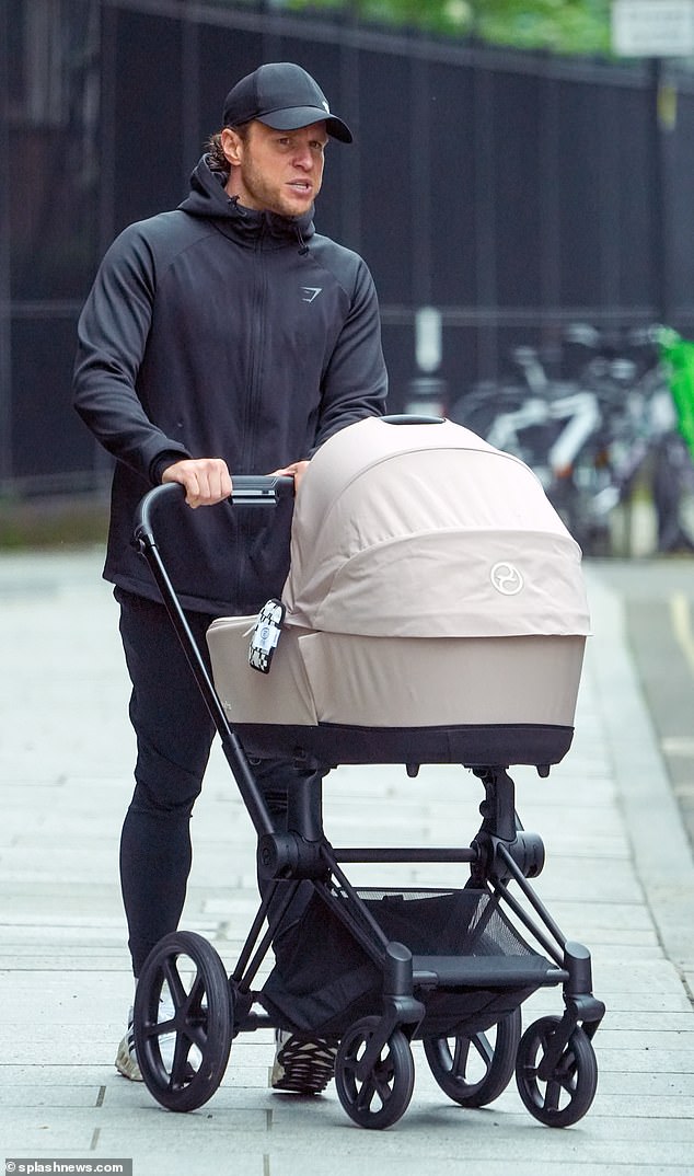 Olly wore a sporty outfit and opted for a black Gymshark jacket and a black baseball cap