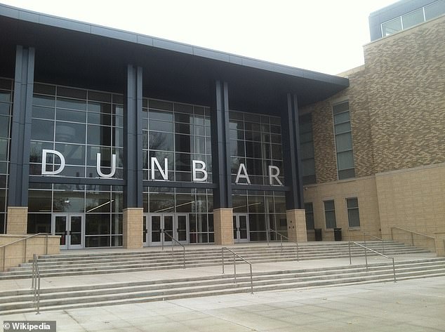 The 17-year-old girl was grazed by the bullet that came through the window of Dunbar High School, according to police