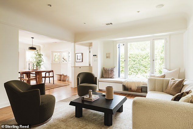 The living room also has a built-in sofa overlooking the front garden and features a Tudor-inspired coved ceiling