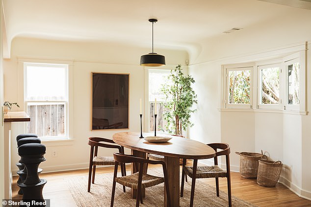 The adjacent dining room flows seamlessly into a modern kitchen