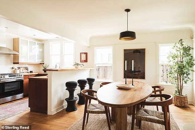 There are more large windows for natural lighting in the home's modern cooking and dining area