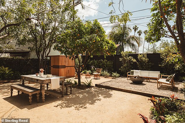 The backyard has plenty of seating areas and a sauna in addition to the lush greenery
