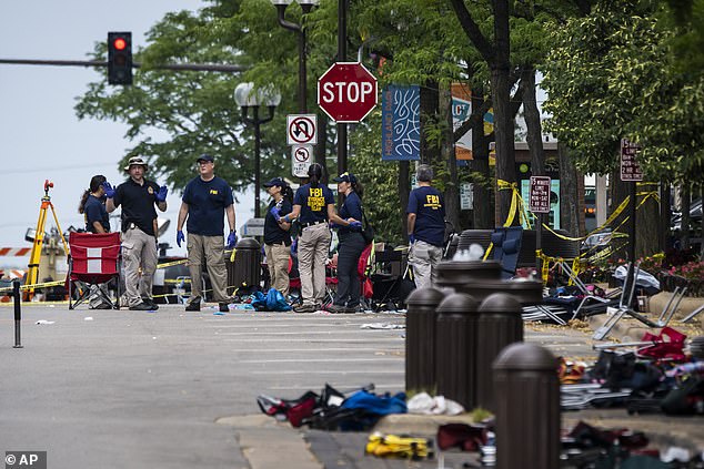 Members of the FBI Evidence Response Team Unit investigate in downtown Highland Park, Illinois, on July 5, 2022, the day after a deadly mass shooting during a Fourth of July parade