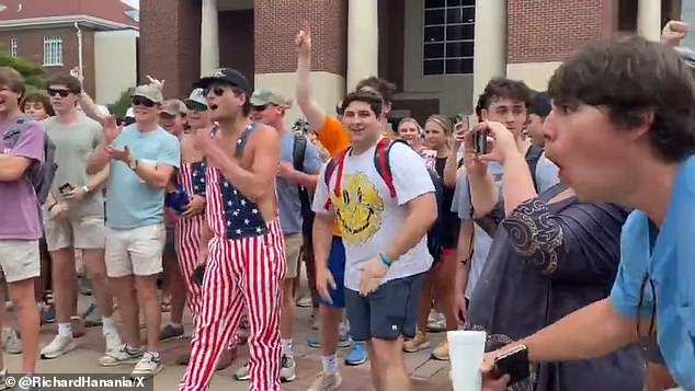 The predominantly white, male counter-protesters hurled insults at women during Thursday's confrontation, including this student in blue on the right making monkey gestures