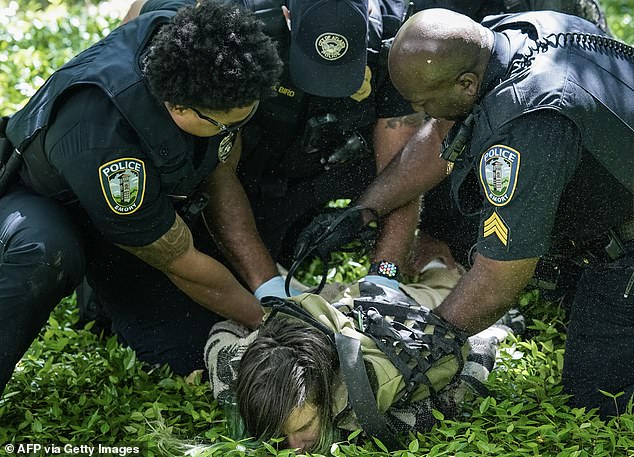 Police officers detain a protester during a pro-Palestinian protest against the war in Gaza at Emory University on April 25, 2024 in Atlanta, Georgia