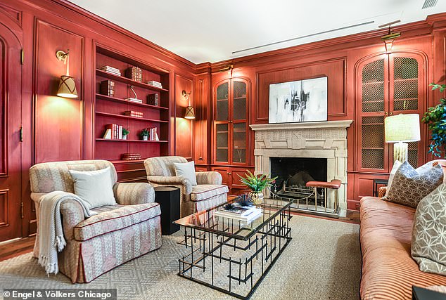 The multi-story mansion also features a paneled library equipped with another fireplace and five full bathrooms and two half baths.