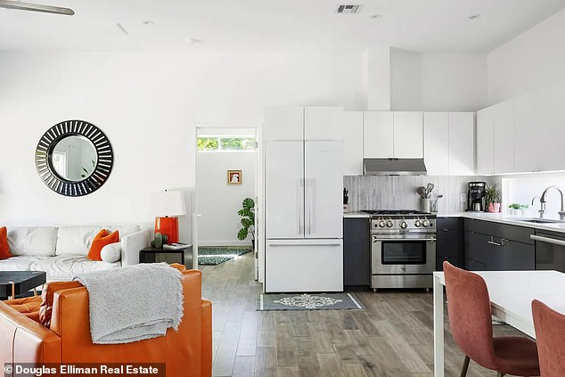 Bright orange accents can be found in the home's finishes, including the cushions, lamps and even a comfortable armchair