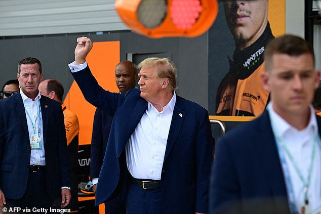 Trump gestured to his supporters in the crowd as he prepared to watch the race begin