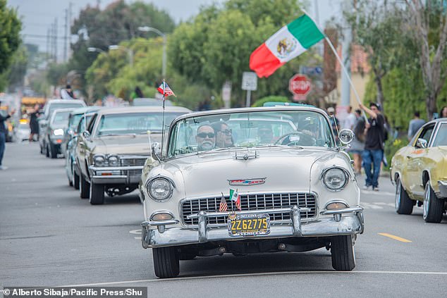 An array of classic cars were displayed to the public as Mexican flags hung from the vehicles