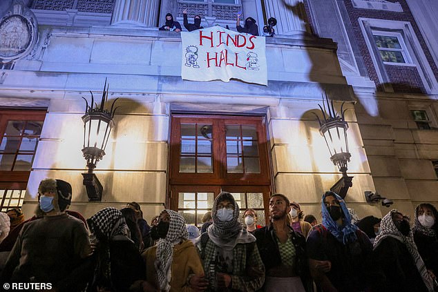 Protesters join arms outside Hamilton Hall to barricade students in the Columbia University building on April 30