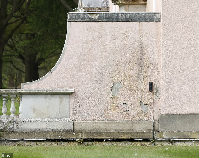 The exterior of the building is covered in peeling paint and needs to be sanded and repainted