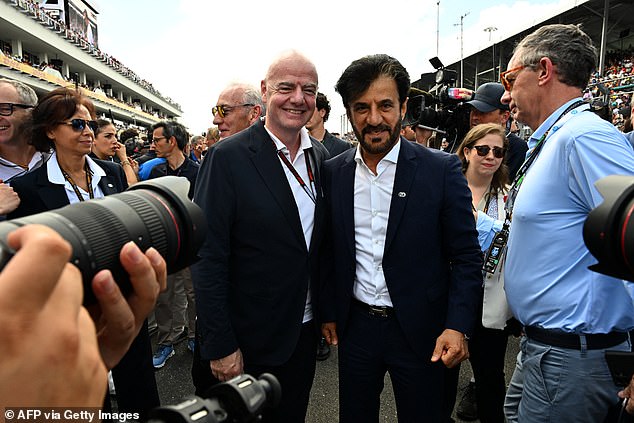 FIA President.  Mohammed Ben Sulayem and FIFA President.  Gianni Infantino poses for a photo on the grid