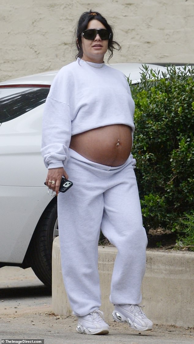 She paired her comfy attire with a pair of white chunky sneakers, and the mom-to-be kept her hair out of her face with a messy bun