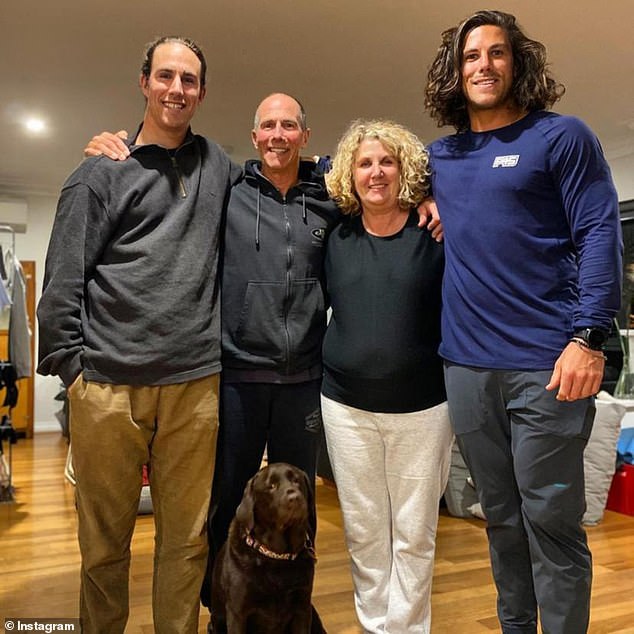 Jake Robinson (left) is pictured with his brother Callum (right) and their parents - who flew from Perth to Mexico to see if they can identify their sons' bodies