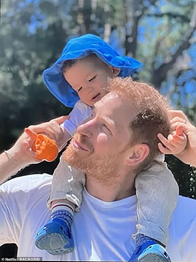 Archie is seen sitting on his father's shoulders in an image revealed in Harry and Meghan's Netflix documentary