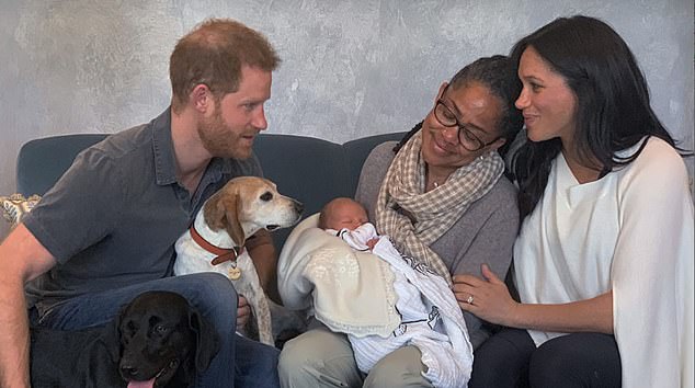 Baby Archie seen in his grandmother Doria Ragland's arms as she sits next to Meghan and Harry at Frogmore Cottage