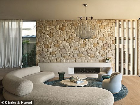 Handcrafted sandstone walls add an earthy touch to the airy space