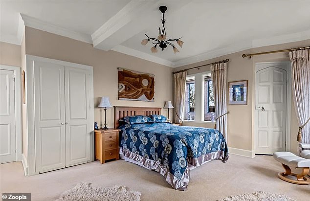 The penthouse has three bedrooms, including these with antique stone mullion windows